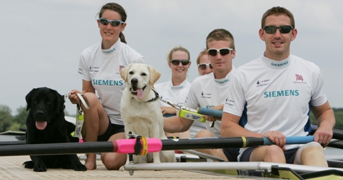 Image of the GB Adaptive Rowing Team and Guide Dogs