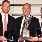 Gregory (left) and Stanning (right) are presented with their trophy by Sir Steve Redgrave (centre)