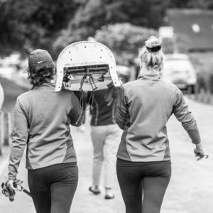 Two women carrying a rowing boat on their shoulders