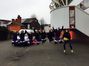 Group of female rowers jumping in the air celebrating