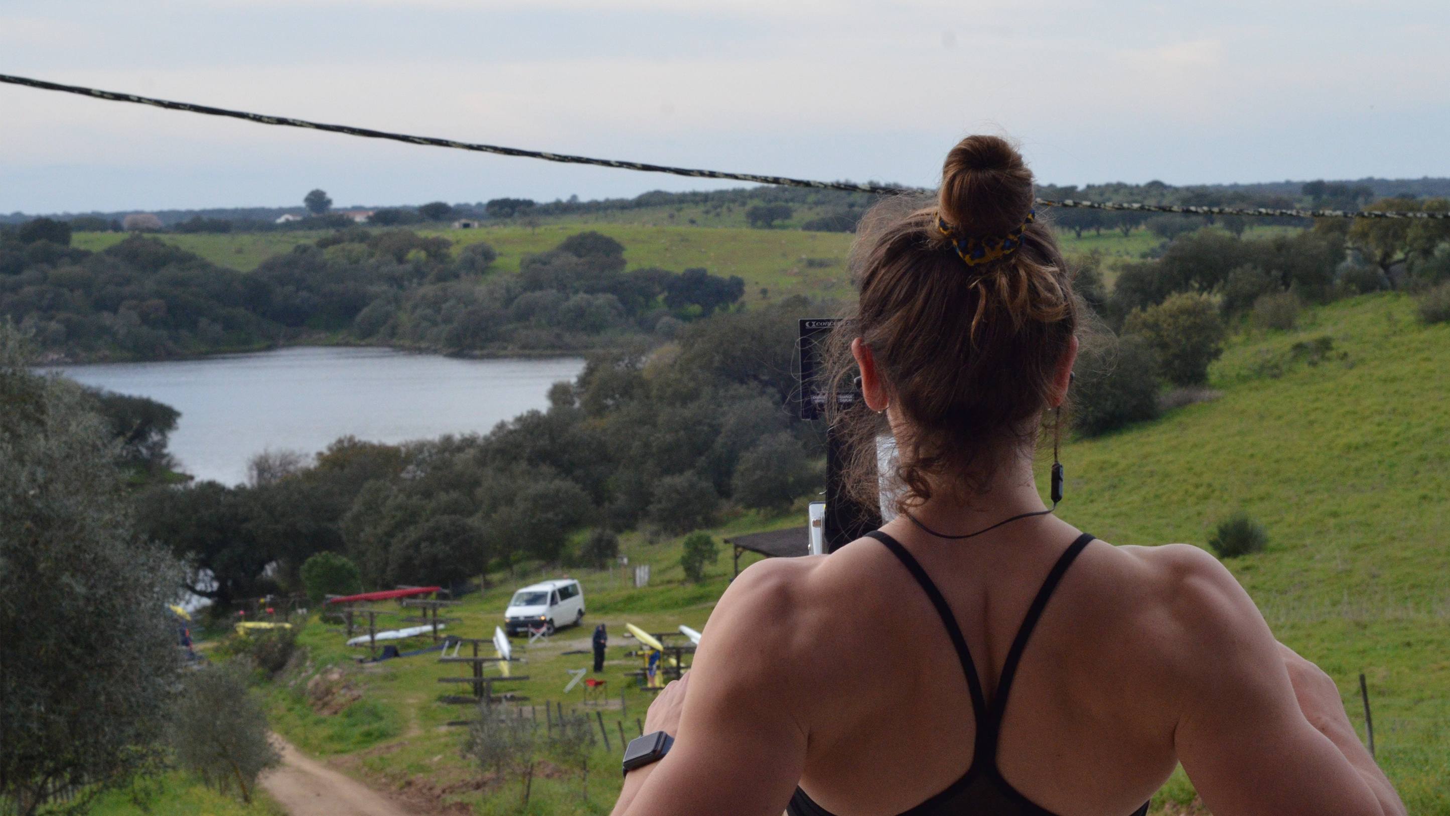 rower on an indoor rowing machine overlooking a lake