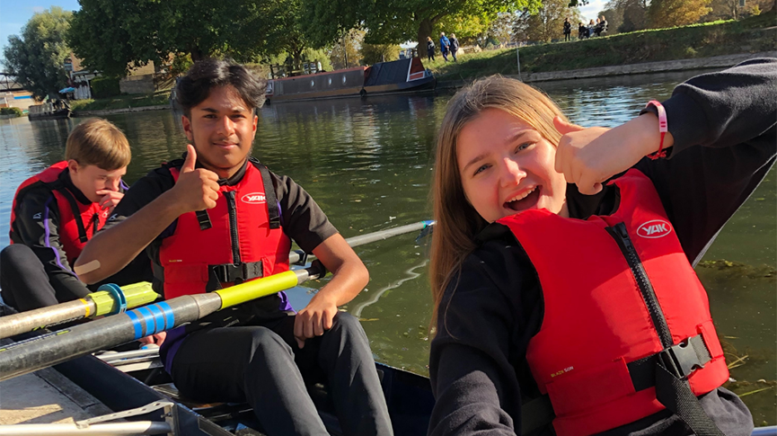 diverse children rowing