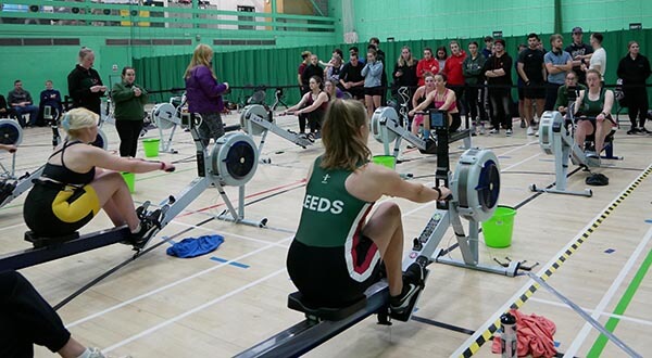 Women on indoor rowing machines