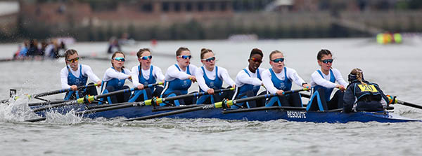 Girls eight racing in blue kit
