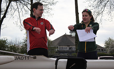 Coach working with buddy rower