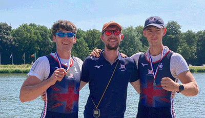 Men's double with medals and coach