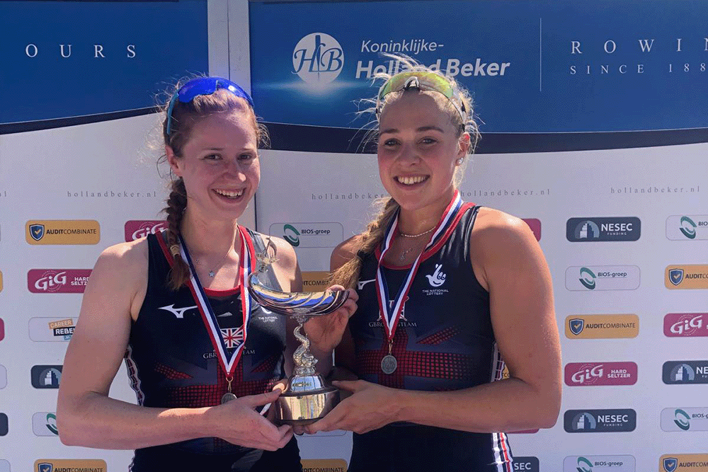 2 women with medals and silver cup