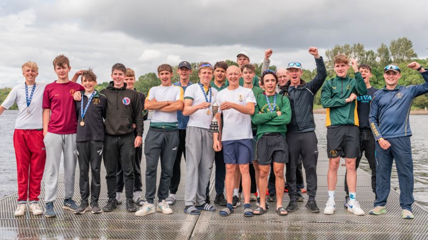 Group of boys and coaches with cup