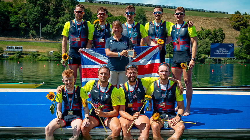 GB men's eight with silver medals on landing stage