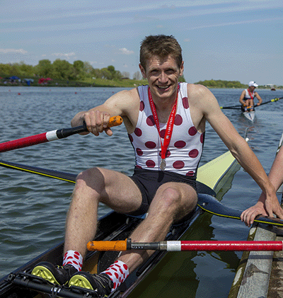 Male sculler in spotted kit with medal