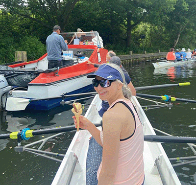 Woman in rowing boat with ice cream