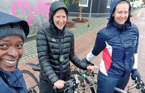 Coaches on bikes in the rain