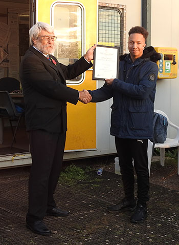 British Rowing's Stephen Worley presenting the Royal Humane Society certificate to Dominic Jones