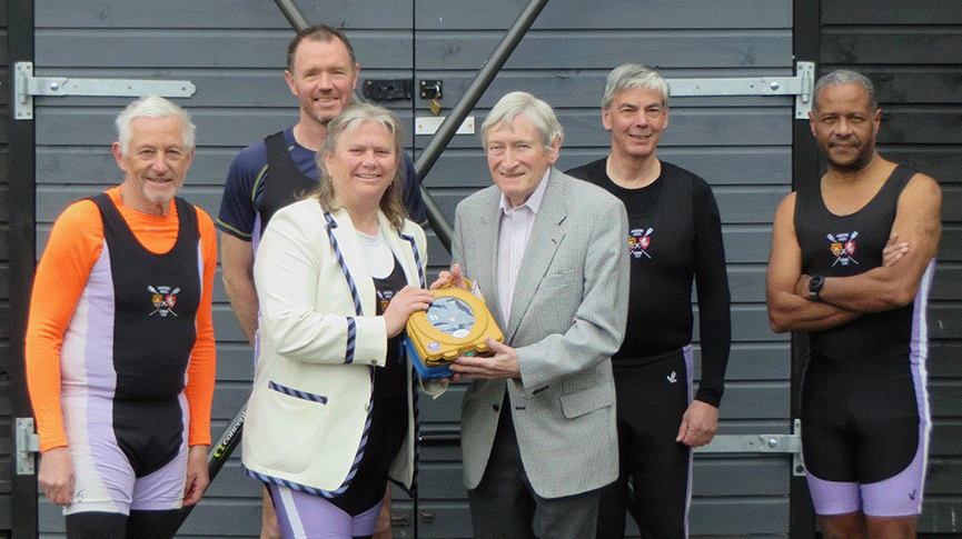 Defibrillator being presented to rowing club Vice President