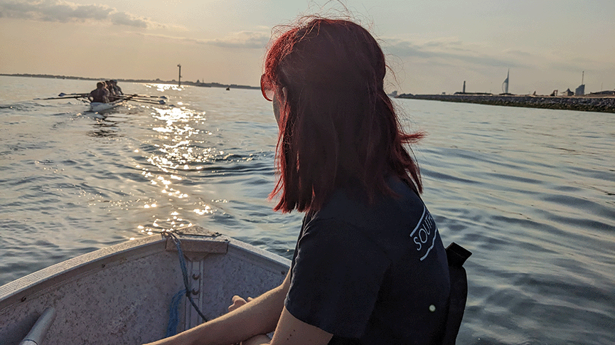Female coach in boat on the water