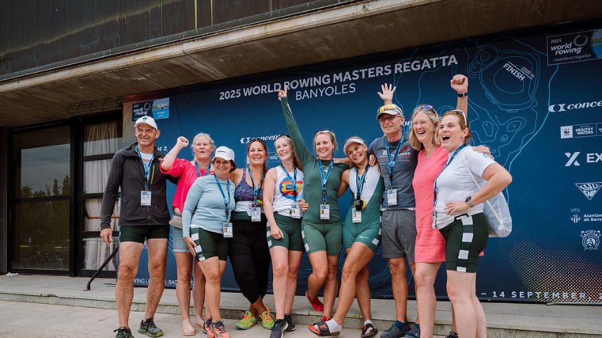 Rowers posing infront of the WRMR banner