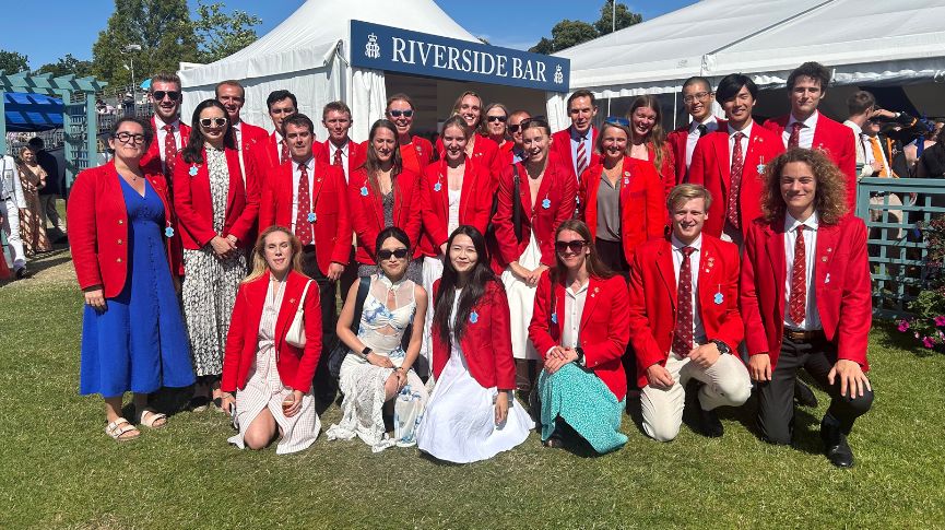 Members of the club in their blazers outside the riverside bar at HRR