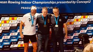 matthew west in the middle of three men with a gold medal round his neck