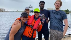 Mary Fearnley in orange pictured with some of the refugees