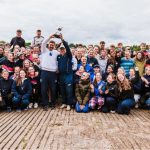 Members of NUMB pose with the VL trophy held by the two coaches