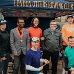 A group of the london otters rowers standing infront of their gazebo