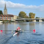 An adaptive pair infront of marlow bridge on the water