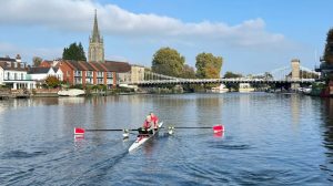 An adaptive pair infront of marlow bridge on the water