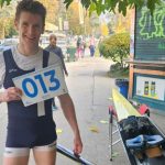 Ben Parsonage holding bow number 13 stood by his boat