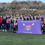 all of reading uni bc pictured in front of newburn bridge with their flag