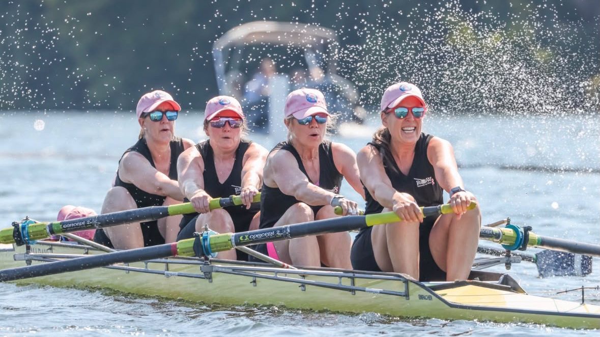 Women's masters Coxed Four racing in black kit